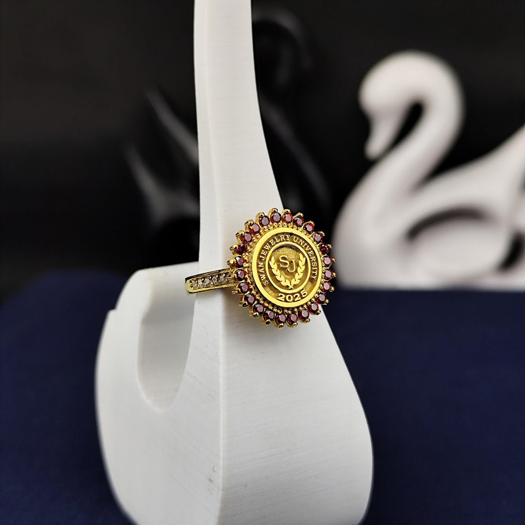 Unique gold-plated women’s college ring with a red stone, offering a round and refined design. Perfect for commemorating educational milestones.
