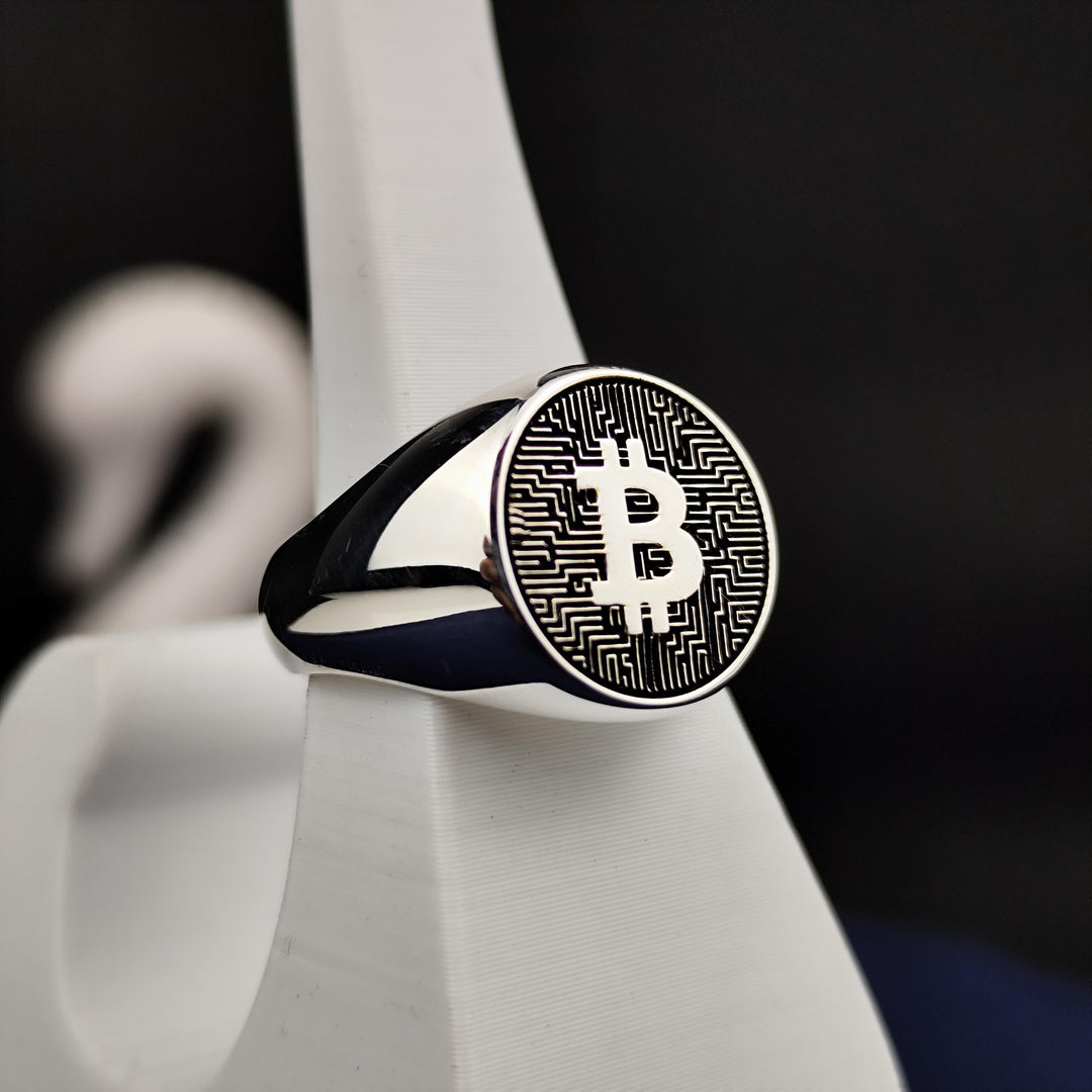 Modern Bitcoin ring in silver, featuring an engraved BTC logo. A perfect statement piece for crypto investors and supporters of decentralized finance.