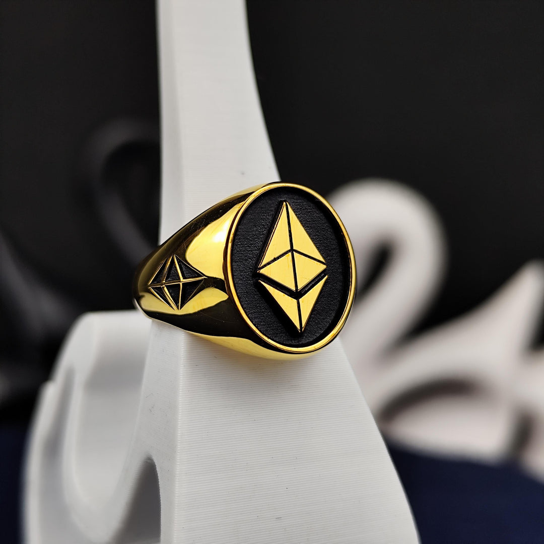 Elegant gold Ethereum ring crafted for blockchain enthusiasts and crypto investors. Featuring a sleek, modern design with high-quality gold plating, this stylish signet ring symbolizes financial innovation and digital wealth. A meaningful statement piece for those who believe in the future of decentralized finance and cryptocurrency. Perfect for everyday wear, special occasions, or as a unique crypto-inspired gift.