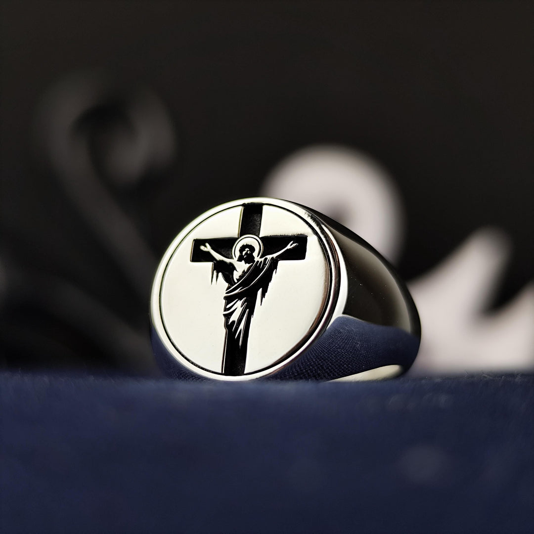 A powerful symbol of faith, this unisex cross and Jesus ring is crafted in high-quality silver with a handmade crucifix signet band. Perfect for those who seek a meaningful piece of religious jewelry, this ring embodies Christian devotion and belief. An ideal Christian gift for Easter, Christmas, or any special occasion, this timeless accessory allows believers to carry their faith with them in an elegant way.