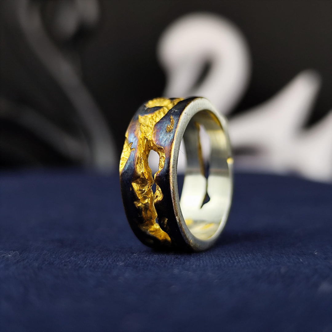 This unique rustic ring, crafted with an oxidized and gold-plated finish, embodies a raw and textured aesthetic. Handmade for those who appreciate vintage and antique jewelry, this statement band is perfect for daily wear or special occasions. The contrast between dark oxidation and warm gold highlights creates a striking visual effect, making it an elegant yet edgy accessory for men and women alike.