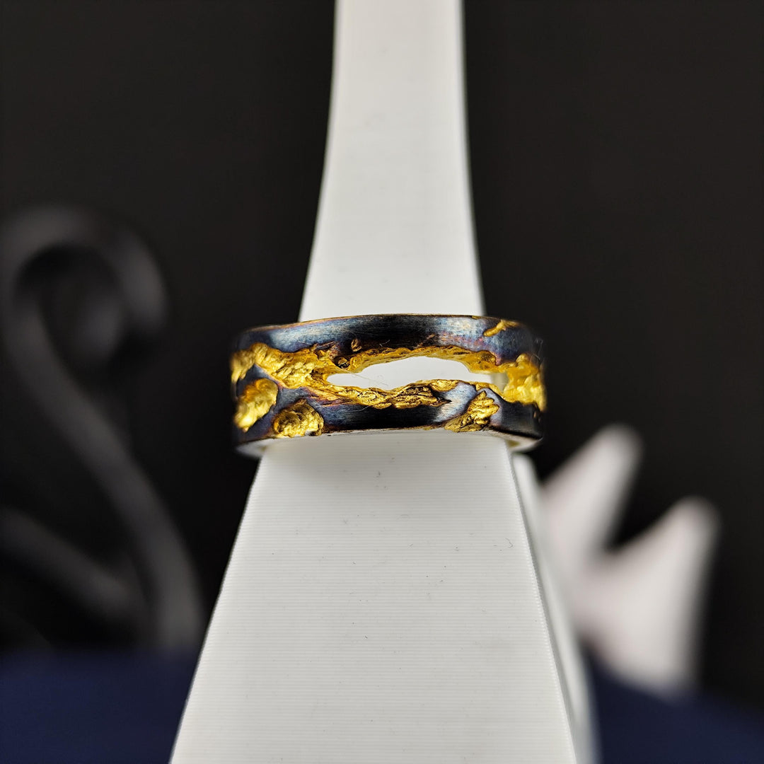 This oxidized and gold-plated rustic ring features a unique textured band that captures the essence of raw elegance. A handcrafted statement piece, this ring is ideal for men and women who seek something bold and different. Perfect for those who love antique aesthetics, this artisanal jewelry piece makes a great everyday ring or a special gift, showcasing a refined balance between ruggedness and sophistication.