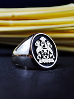 Load image into Gallery viewer, Celebrate your heritage with this custom silver coat of arms ring, featuring a deeply engraved family crest. Designed to be a distinguished heirloom, this heraldic signet ring is a timeless accessory that embodies tradition. A sophisticated and meaningful jewelry piece for those who appreciate their ancestry and historical legacy.
