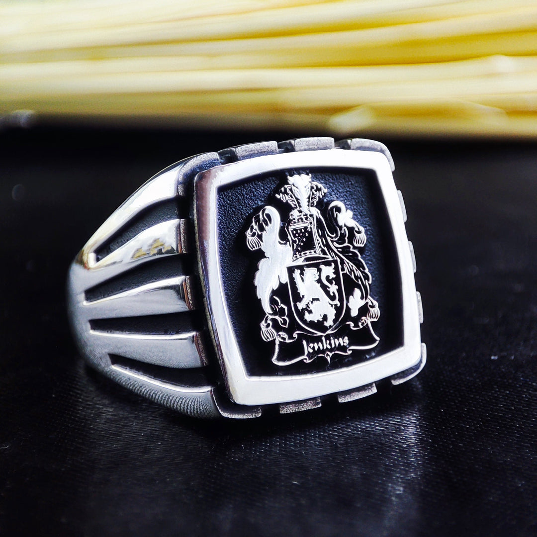 This personalized square signet ring is crafted in solid silver, featuring a detailed engraving of a custom family logo. A distinguished piece for men who appreciate heritage and legacy, this crest ring is perfect as an heirloom gift. Whether commemorating a historical lineage or creating a new family symbol, this ring represents strength, tradition, and elegance.