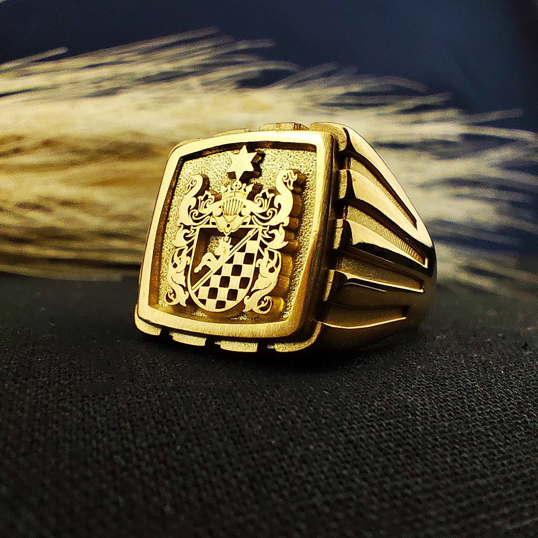 A bold and sophisticated gold-plated family crest ring, crafted with a square design to highlight its intricate engraving. This heraldic signet ring is perfect for men who appreciate classic and vintage-style jewelry. Personalize it with a coat of arms, initials, or custom emblem to create a unique, noble keepsake that represents tradition, heritage, and legacy.