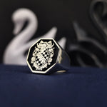 Load image into Gallery viewer, A bold and elegant octagonal heraldic ring, crafted in sterling silver and highlighted with black enamel detailing. This coat of arms signet ring is designed for those who appreciate heritage and legacy. Whether as a personalized heirloom, a meaningful gift, or a statement accessory, this unique ring is a distinguished and timeless symbol of family pride.
