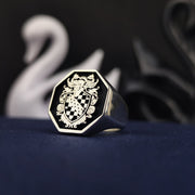 A bold and elegant octagonal heraldic ring, crafted in sterling silver and highlighted with black enamel detailing. This coat of arms signet ring is designed for those who appreciate heritage and legacy. Whether as a personalized heirloom, a meaningful gift, or a statement accessory, this unique ring is a distinguished and timeless symbol of family pride.
