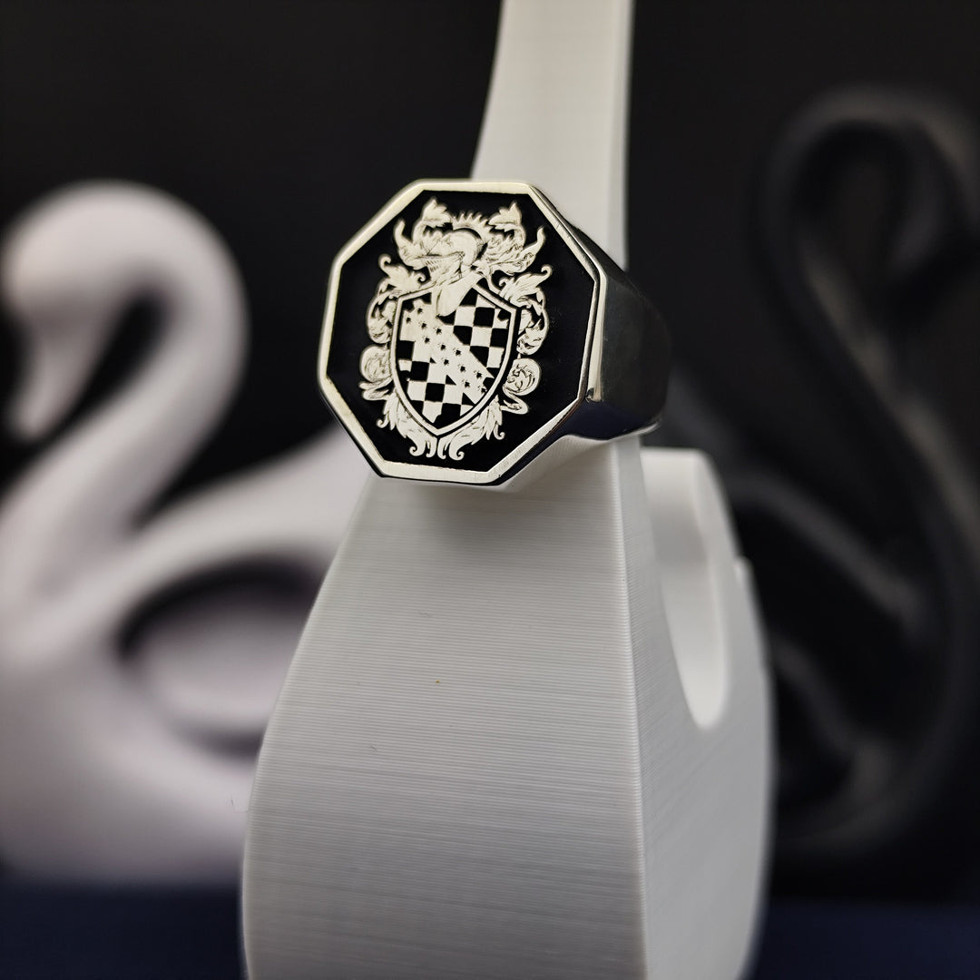 A meticulously crafted silver signet ring with an octagonal shape, featuring an engraved family crest and black enamel finish. Designed for those who appreciate fine craftsmanship and historical significance, this noble heritage ring is a timeless heirloom. A thoughtful gift for those who wish to carry their family history with elegance and pride.