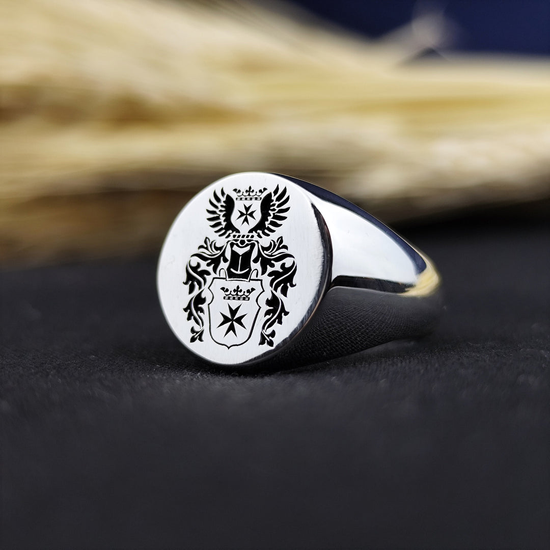 This personalized round signet ring is a sophisticated family heirloom, designed with a recessed coat of arms engraving. Crafted for durability and elegance, it represents strength, history, and personal legacy. Whether worn as a statement ring or gifted for a special occasion, this custom engraved crest ring is an exceptional piece of heritage jewelry.