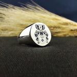 Load image into Gallery viewer, This recessed family crest ring is a bold and elegant statement piece, featuring a custom engraving of a coat of arms. The round signet design is crafted for men who value legacy and heritage. Whether given as a meaningful heirloom or worn as a daily emblem of family pride, this personalized ring is a tribute to ancestry and timeless craftsmanship.
