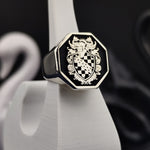 Load image into Gallery viewer, This sterling silver octagon ring is a bold and meaningful tribute to noble lineage. Featuring a precisely engraved coat of arms with enamel detailing, this heraldic signet ring is a powerful symbol of tradition. A perfect accessory for those who cherish history and legacy, making it an exceptional family heirloom or personal statement piece.
