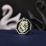 Load image into Gallery viewer, This octagonal coat of arms ring is a custom-engraved silver masterpiece, perfect for those who want to preserve their lineage in a refined jewelry piece. The black enamel enhances the detailed engraving, making it an eye-catching and meaningful accessory. Ideal for commemorating personal or family history, making it a sophisticated and treasured heirloom.
