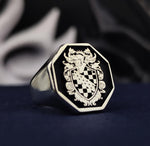 Load image into Gallery viewer, This heraldic family crest ring is an exquisite heirloom, designed with an octagonal silver signet and black enamel finishing. A perfect blend of history and craftsmanship, this ring is custom-engraved with a coat of arms or initials. Whether for personal wear or as a thoughtful gift, it is a lasting symbol of nobility, strength, and tradition.
