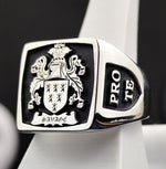 Load image into Gallery viewer, A striking square heraldic signet ring, crafted in silver with a deep black enamel finish. The detailed coat of arms engraving highlights the legacy of noble families, making it a refined heirloom piece. Designed for those who appreciate personalized heritage jewelry, this ring is a timeless representation of strength and tradition, perfect for daily wear or special occasions.
