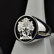 A refined round signet ring, crafted in sterling silver with a personalized family crest engraving and black enamel finish. This noble and sophisticated piece is perfect for those who cherish their heritage. Whether passed down as a family heirloom or worn as a daily emblem of history and pride, this custom coat of arms ring is a striking tribute to tradition and legacy.