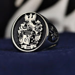 Load image into Gallery viewer, Personalized silver signet ring with a detailed family emblem. This ring combines elegance with the meaning of heritage, perfect for gifting.
