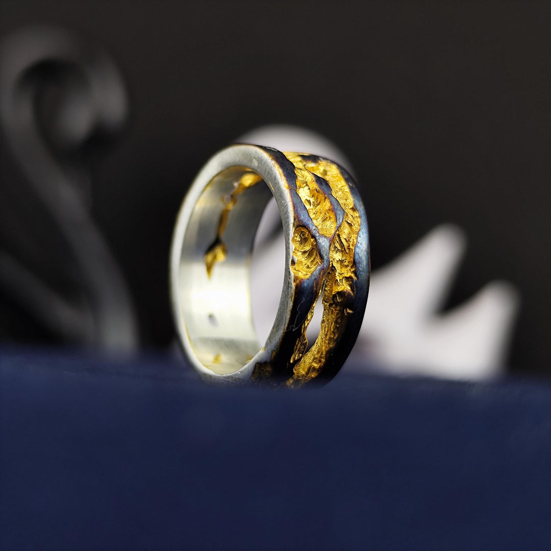 This rustic oxidized and gold-plated ring is a unique blend of vintage charm and modern craftsmanship. Its textured surface creates an artisanal statement piece that suits both men and women. Perfect for daily wear or as a thoughtful gift, this handmade band brings an antique-inspired, organic look that stands out with its rich contrast and raw elegance, making it a one-of-a-kind jewelry piece.